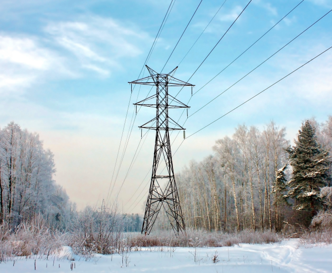 Electric power transmission tower in snowy winter landscape. Electric power transmission tower in snowy winter landscape.