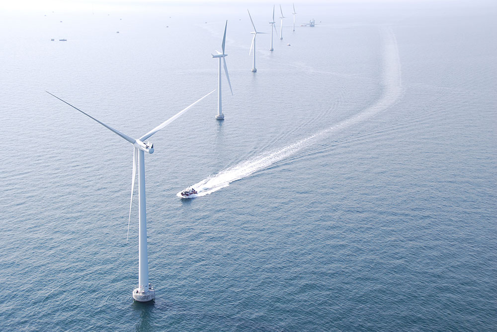 Offshore wind turbines at sea with clear sky. Offshore wind turbines at sea with clear sky.